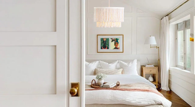 Bedroom decor ideas include hanging the Framed Art Print - Makeda from 54kibo to add a striking detail in a neutral bedroom.