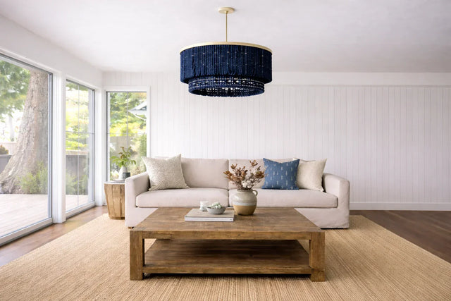 White living room with wood center table and sculptural wood beads chandelier; is custom furniture worth it.
