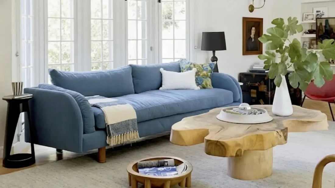 Calm living room with blue sofa and natural wood tables, seasonal home rituals