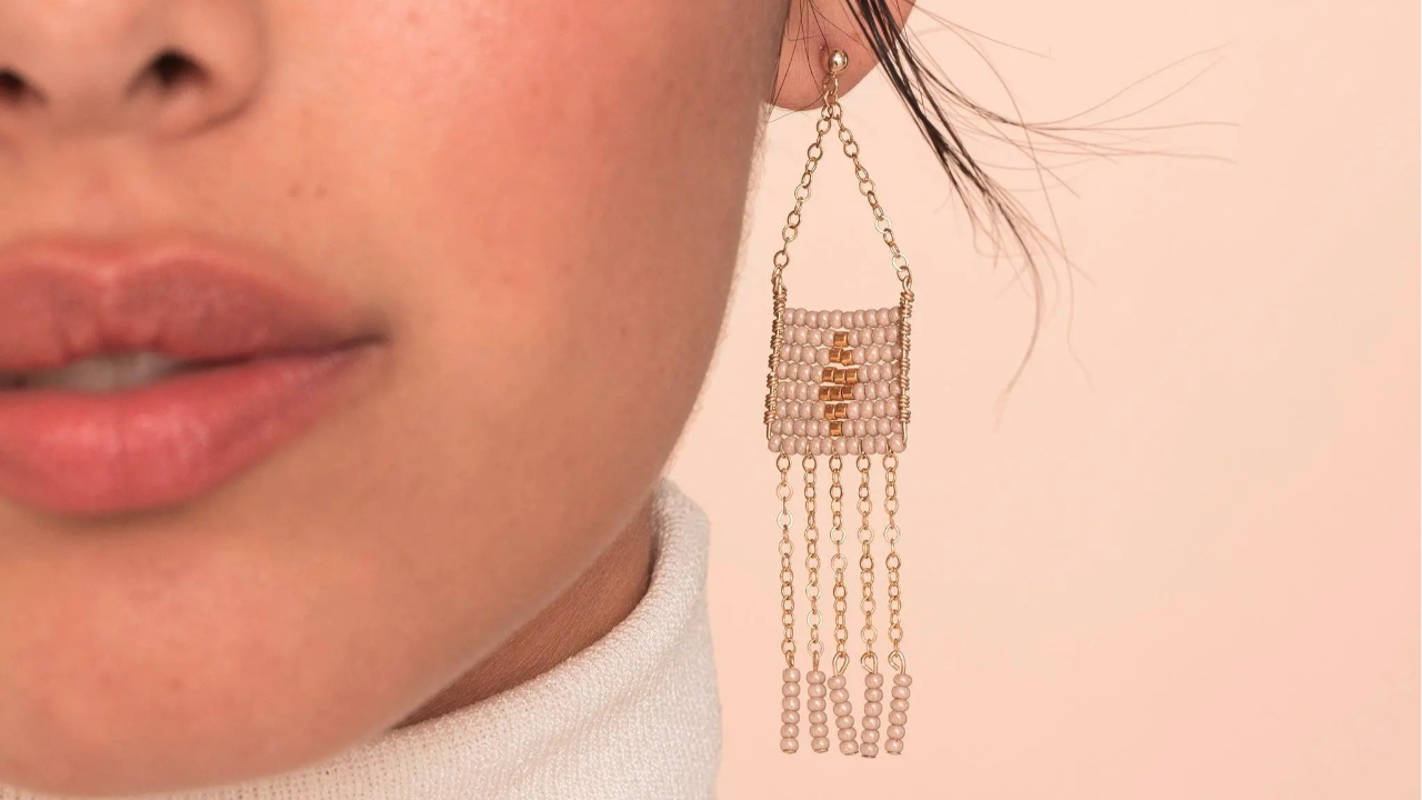 The handmade White Long Beaded Earrings from 54kibo features gold chains and glass beads, the perfect gift for girls who want to add a touch of sophistication to their looks.