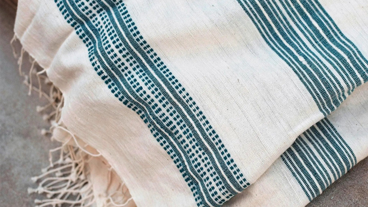 The handwoven Tana Teal Bath Towel from 54kibo is a practical gift for boys and tweens who are learning to be independent.